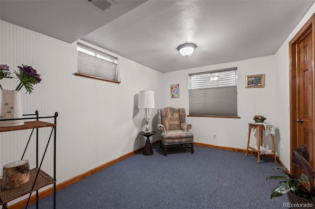 living area with carpet flooring, visible vents, and baseboards