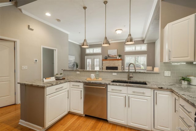 880 E 16th Ave Unit D, Denver, CO 80218 - kitchen with stainless steel dishwasher, a sink, light wood-type flooring, tasteful backsplash, and crown molding