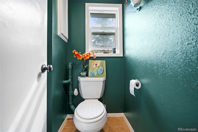 bathroom with toilet and tile patterned flooring