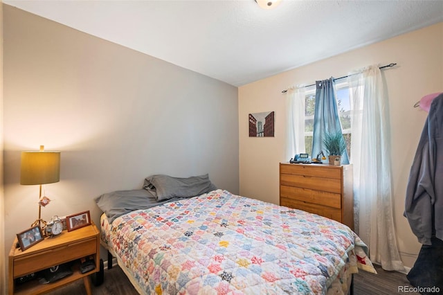 bedroom with dark wood-type flooring