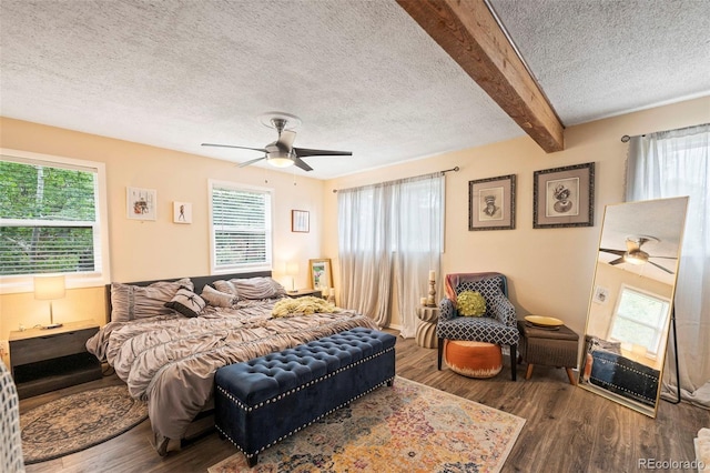 bedroom with multiple windows, ceiling fan, and dark wood-type flooring