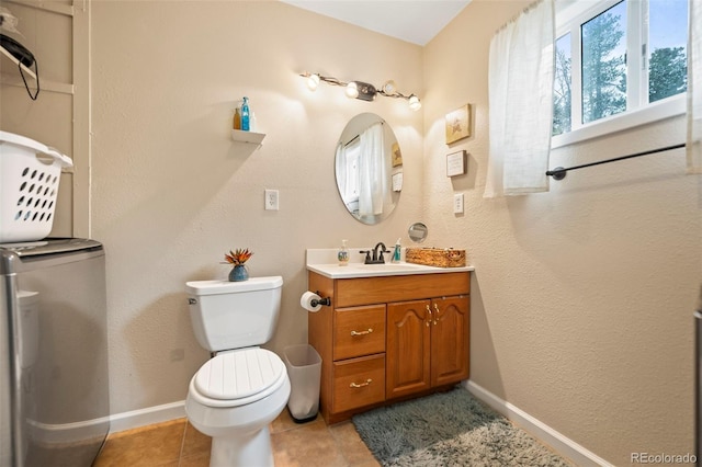 bathroom with vanity, toilet, and tile patterned flooring