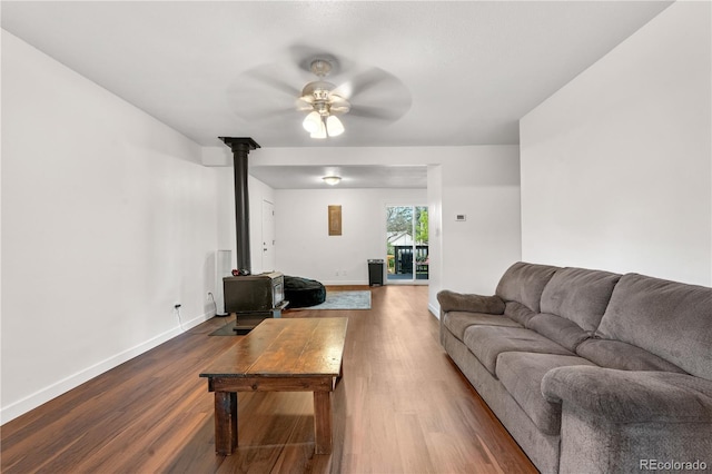 8820 Poze Blvd, Thornton, CO 80229 - living area with a wood stove, dark wood finished floors, and a ceiling fan