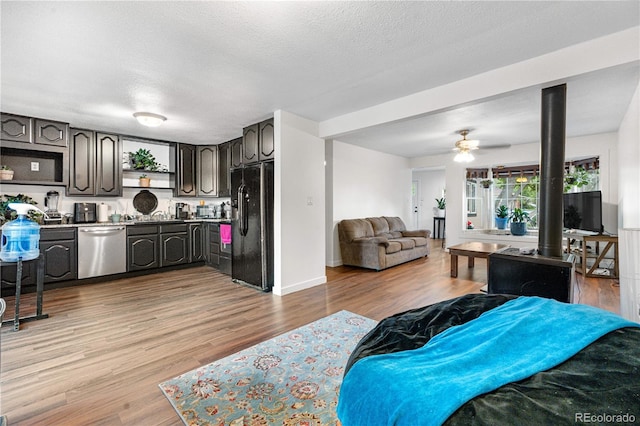 8820 Poze Blvd, Thornton, CO 80229 - living room featuring light wood-style floors, ceiling fan, and a textured ceiling