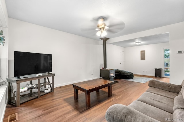 8820 Poze Blvd, Thornton, CO 80229 - living area with a wood stove, a ceiling fan, wood finished floors, and electric panel