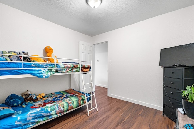 8820 Poze Blvd, Thornton, CO 80229 - bedroom with wood finished floors and a textured ceiling