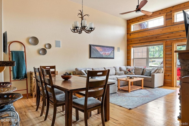 220 Reunion Ct, Fraser, CO 80442 - dining area featuring ceiling fan, light wood finished floors, wood walls, and a chandelier