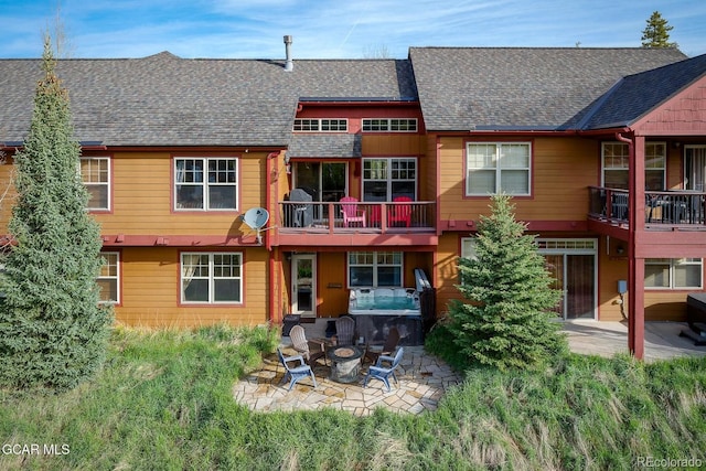 220 Reunion Ct, Fraser, CO 80442 - back of property with an outdoor fire pit, roof with shingles, and a patio