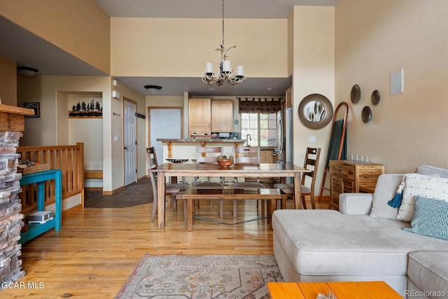220 Reunion Ct, Fraser, CO 80442 - living area with a chandelier, light wood-type flooring, and a towering ceiling