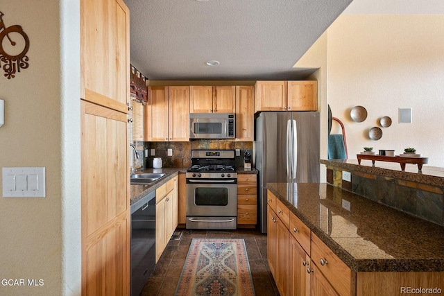 220 Reunion Ct, Fraser, CO 80442 - kitchen featuring appliances with stainless steel finishes, tasteful backsplash, dark countertops, a textured ceiling, and light brown cabinets