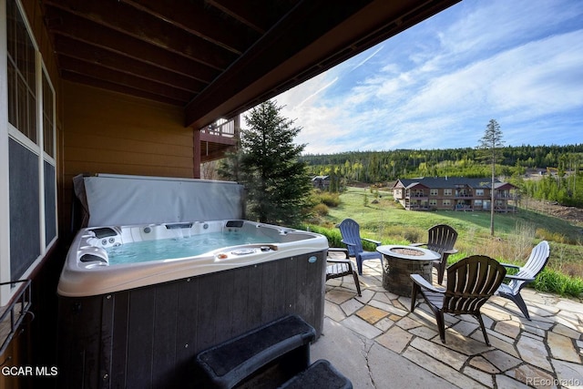 220 Reunion Ct, Fraser, CO 80442 - view of patio / terrace featuring an outdoor fire pit, a hot tub, and a forest view