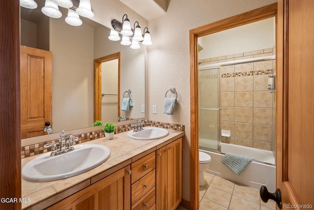 220 Reunion Ct, Fraser, CO 80442 - full bath with double vanity, tile patterned flooring, and bath / shower combo with glass door