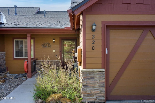 220 Reunion Ct, Fraser, CO 80442 - view of exterior entry with a shingled roof and stone siding