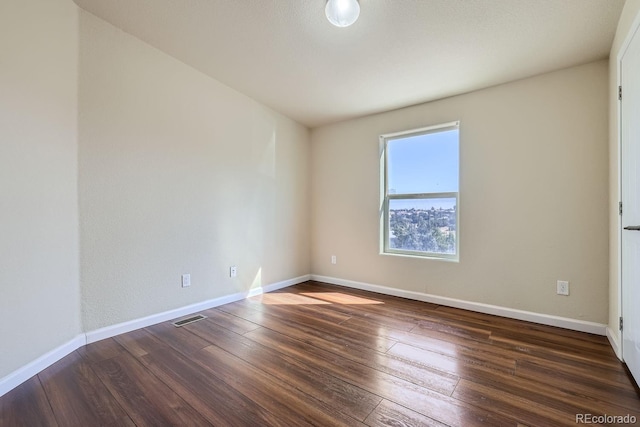 empty room with dark hardwood / wood-style floors