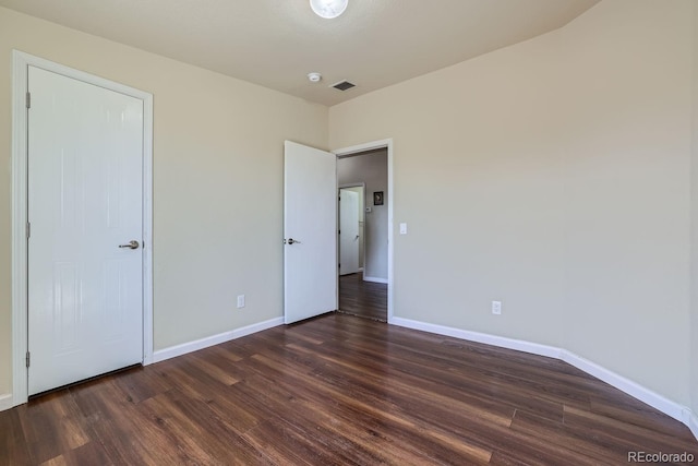 unfurnished bedroom featuring dark hardwood / wood-style flooring