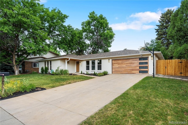 6643 W Roxbury Pl, Littleton, CO 80128 - view of front of house featuring an attached garage, driveway, and stucco siding
