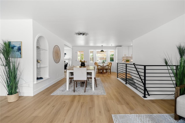 6643 W Roxbury Pl, Littleton, CO 80128 - dining space featuring light wood-type flooring and built in shelves
