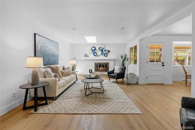 6643 W Roxbury Pl, Littleton, CO 80128 - living area with a skylight, wood finished floors, a fireplace, and recessed lighting