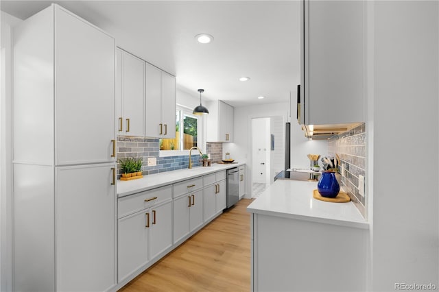 6643 W Roxbury Pl, Littleton, CO 80128 - kitchen featuring stainless steel dishwasher, recessed lighting, backsplash, and light countertops