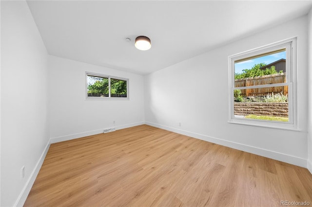 6643 W Roxbury Pl, Littleton, CO 80128 - unfurnished room featuring plenty of natural light and light wood finished floors