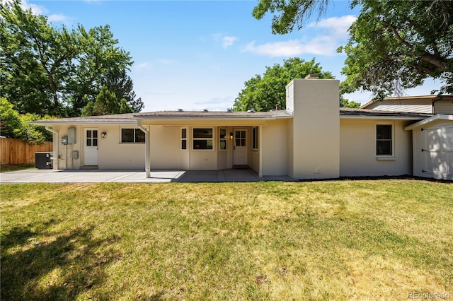 6643 W Roxbury Pl, Littleton, CO 80128 - back of property featuring a patio, a chimney, and stucco siding