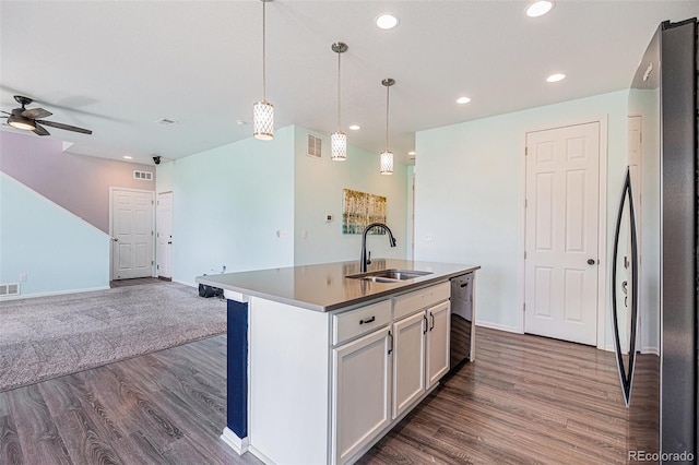 kitchen featuring a sink, freestanding refrigerator, dark wood-style flooring, and open floor plan