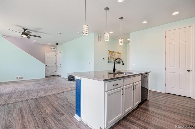 kitchen featuring a sink, open floor plan, dark wood-style floors, and visible vents