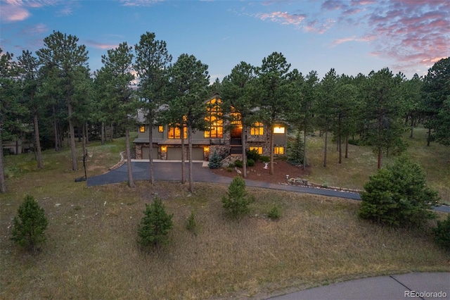 29210 Northstar Ln, Evergreen, CO 80439 - rear view of house featuring driveway, an attached garage, and stairs