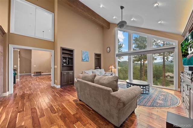 29210 Northstar Ln, Evergreen, CO 80439 - living room featuring high vaulted ceiling, wood finished floors, and beamed ceiling