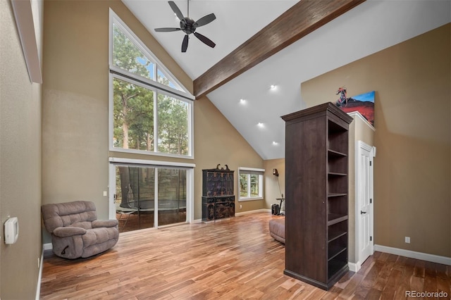 29210 Northstar Ln, Evergreen, CO 80439 - living room featuring high vaulted ceiling, ceiling fan, wood finished floors, and beam ceiling