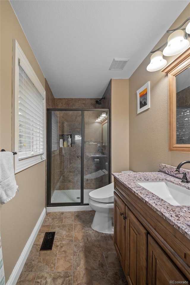 29210 Northstar Ln, Evergreen, CO 80439 - bathroom featuring vanity, a shower stall, and stone finish flooring