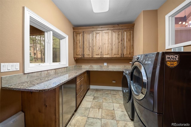 29210 Northstar Ln, Evergreen, CO 80439 - laundry room with cabinet space, washing machine and dryer, and light stone finish floors
