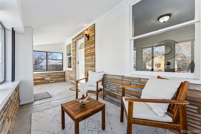 sunroom featuring lofted ceiling