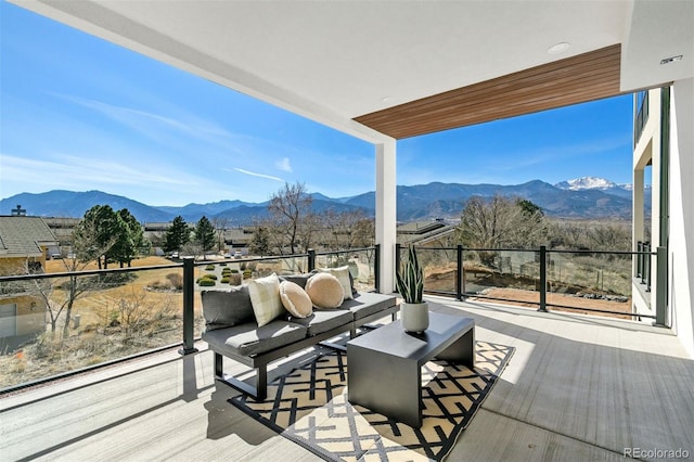 wooden deck featuring an outdoor living space and a mountain view