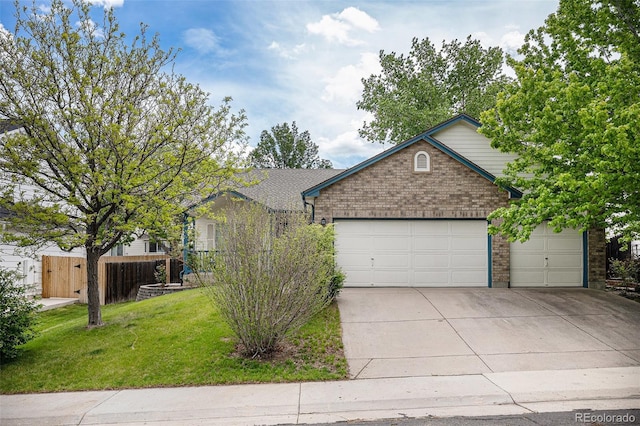 5214 S Tibet St, Aurora, CO 80015 - view of front of property featuring driveway, an attached garage, and brick siding