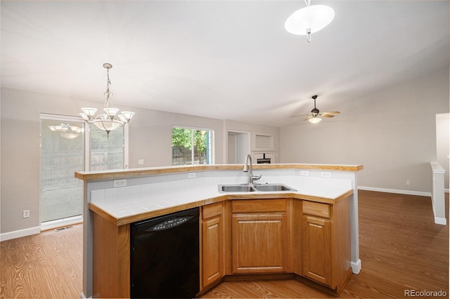 5214 S Tibet St, Aurora, CO 80015 - kitchen with dishwasher, a sink, light wood-type flooring, baseboards, and a ceiling fan
