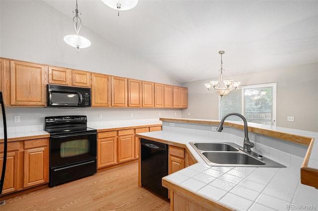 5214 S Tibet St, Aurora, CO 80015 - kitchen with black appliances, a sink, lofted ceiling, tile counters, and a chandelier