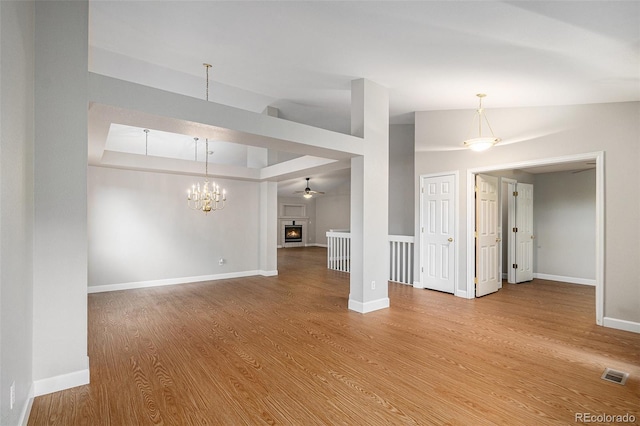 5214 S Tibet St, Aurora, CO 80015 - unfurnished living room featuring wood finished floors, lofted ceiling, a chandelier, baseboards, and ceiling fan