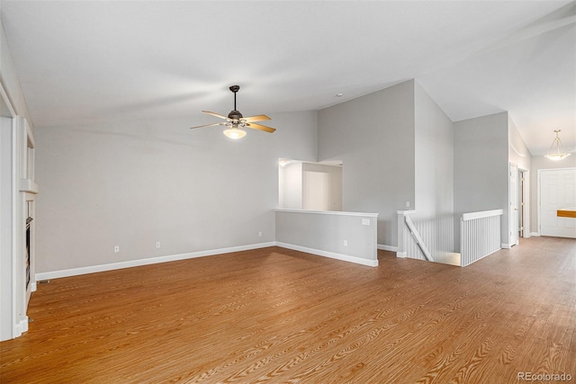 5214 S Tibet St, Aurora, CO 80015 - spare room with vaulted ceiling, ceiling fan, wood finished floors, and baseboards