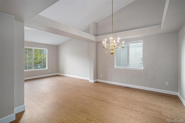 5214 S Tibet St, Aurora, CO 80015 - spare room with a chandelier, wood finished floors, vaulted ceiling, and baseboards