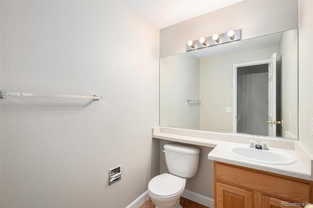 5214 S Tibet St, Aurora, CO 80015 - bathroom featuring toilet, vanity, and baseboards