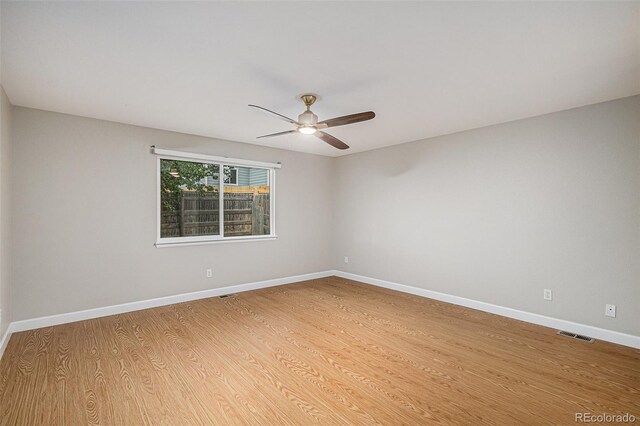 5214 S Tibet St, Aurora, CO 80015 - spare room featuring a ceiling fan, light wood finished floors, and baseboards