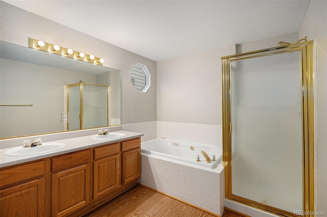 5214 S Tibet St, Aurora, CO 80015 - full bath with a stall shower, double vanity, a garden tub, and wood finished floors