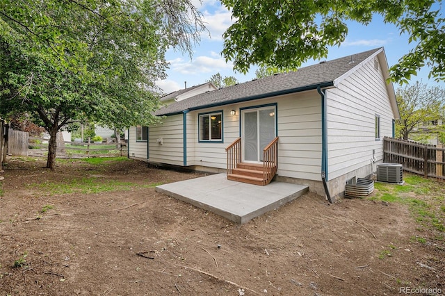 5214 S Tibet St, Aurora, CO 80015 - rear view of property featuring entry steps, a patio, central AC, and a shingled roof