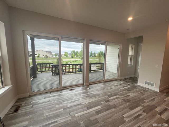 1613 Winter Glow Dr, Windsor, CO 80550 - spare room with wood finished floors, baseboards, and recessed lighting