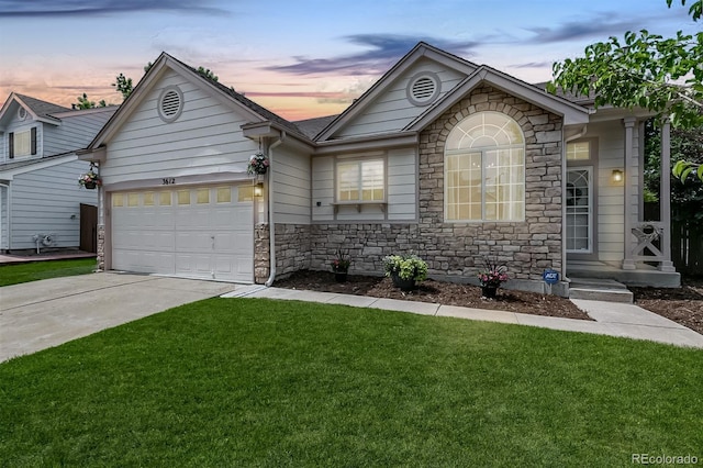 3612 Rosewalk Cir, Highlands Ranch, CO 80129 - view of front facade featuring stone siding, concrete driveway, a lawn, and an attached garage