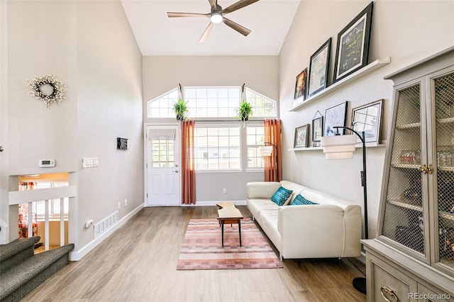 3612 Rosewalk Cir, Highlands Ranch, CO 80129 - living area featuring wood finished floors, ceiling fan, high vaulted ceiling, and stairs