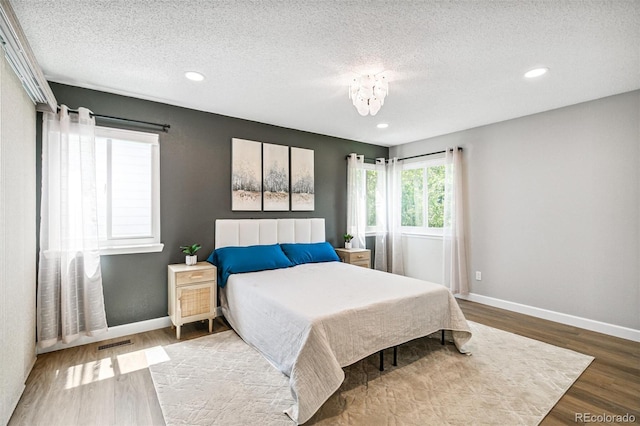 3612 Rosewalk Cir, Highlands Ranch, CO 80129 - bedroom with wood finished floors, a textured ceiling, and recessed lighting