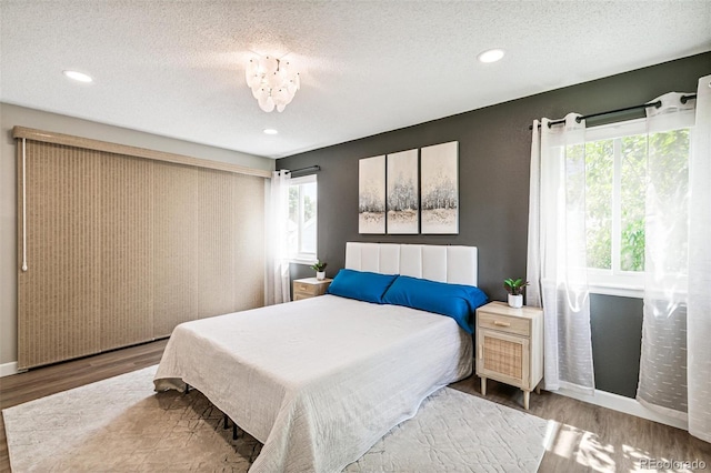 3612 Rosewalk Cir, Highlands Ranch, CO 80129 - bedroom featuring wood finished floors, multiple windows, a textured ceiling, and recessed lighting