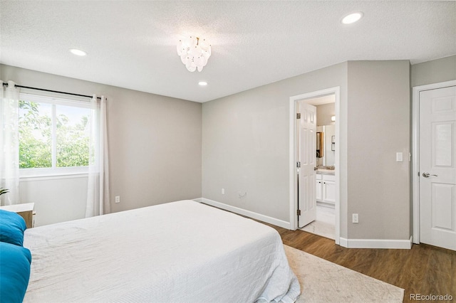 3612 Rosewalk Cir, Highlands Ranch, CO 80129 - bedroom with wood finished floors, recessed lighting, a textured ceiling, and ensuite bath